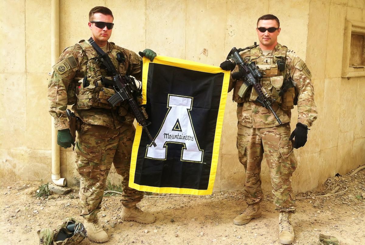 soldiers holding App State Banner during deployment in Iraq