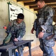 Cadet Pritchett assembling a weapon in front of an instructor